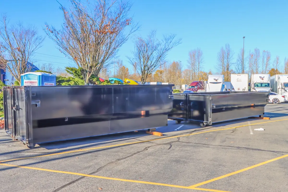 Professional dumpster rental service with roll-off container on residential driveway in Flowing Wells